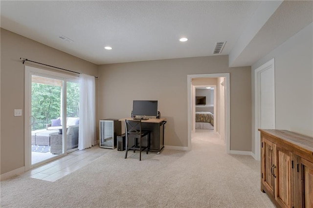 office space featuring light colored carpet, visible vents, baseboards, and recessed lighting