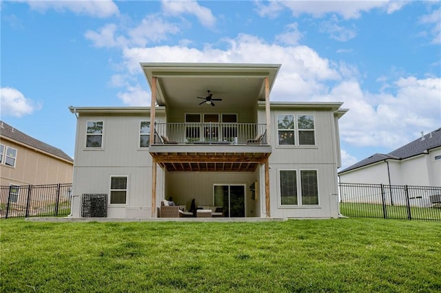 back of house with a balcony, fence, an outdoor living space, a ceiling fan, and a lawn