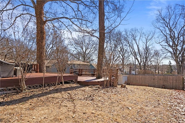 view of yard with a deck and fence