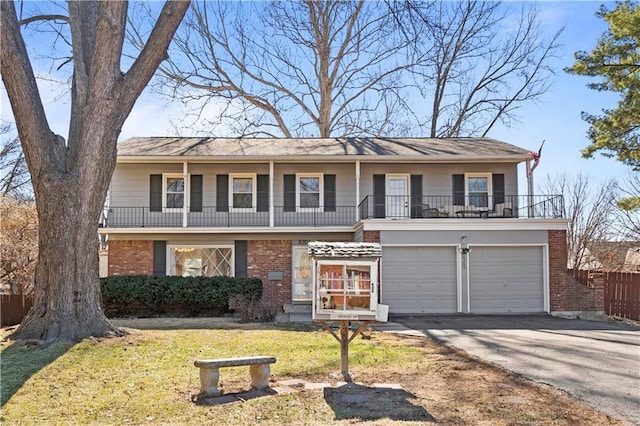 front of property with a balcony, a garage, brick siding, driveway, and a front lawn