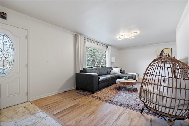 living area featuring wood finished floors and baseboards