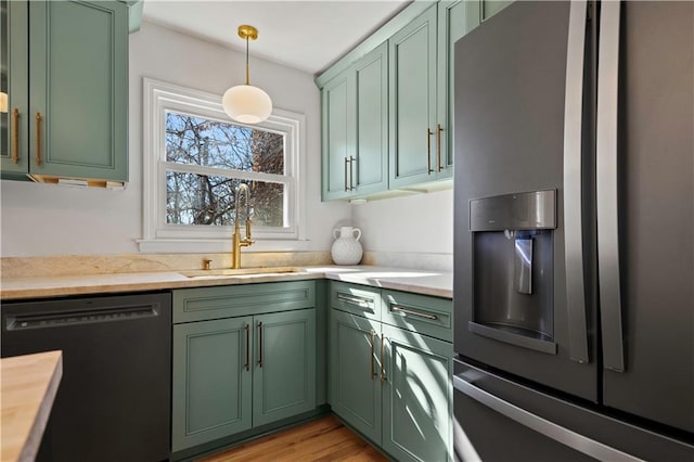 kitchen featuring stainless steel fridge and green cabinets