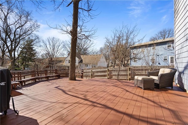 wooden terrace featuring fence