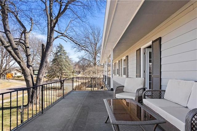 view of patio with outdoor lounge area and a balcony