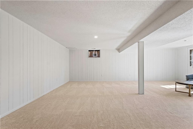 finished basement featuring carpet floors, recessed lighting, and a textured ceiling