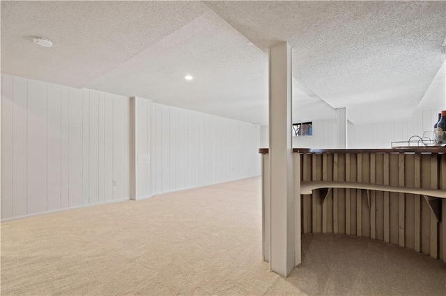 basement with a textured ceiling and carpet floors