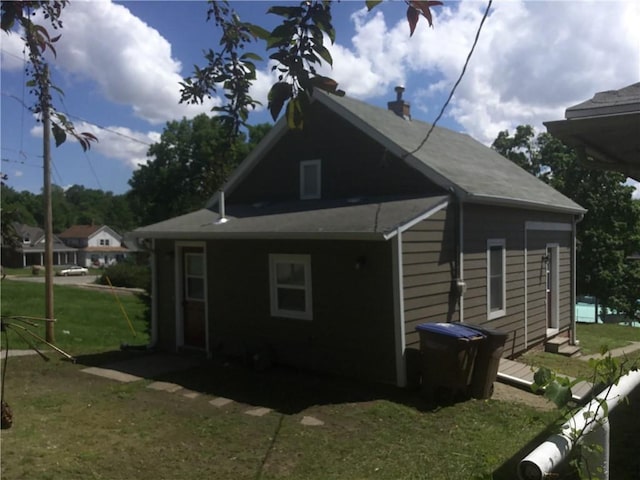 view of side of home with a yard