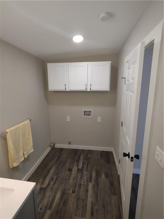 laundry room featuring cabinet space, hookup for a washing machine, baseboards, and dark wood-style flooring