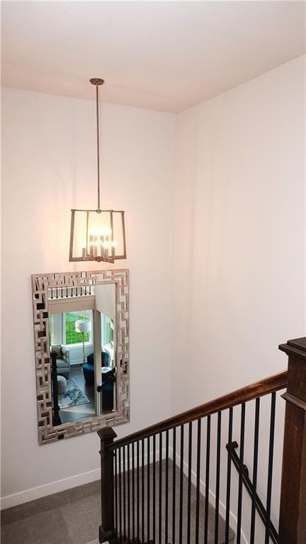 stairs with baseboards and a notable chandelier