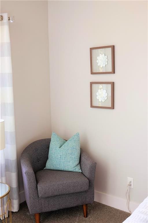 sitting room featuring carpet floors and baseboards