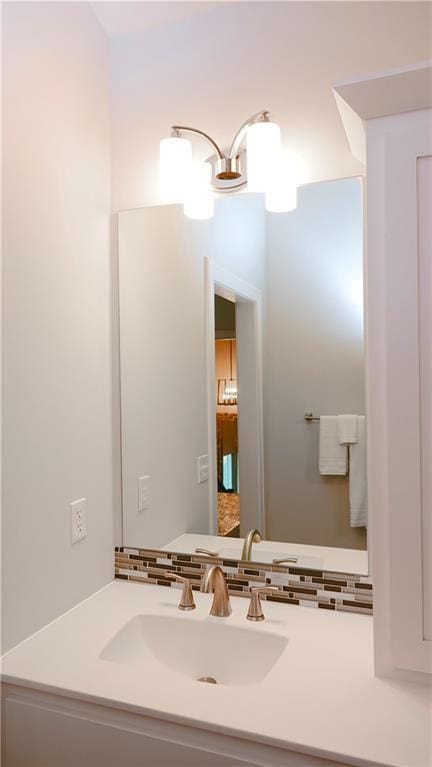 bathroom with a chandelier, tasteful backsplash, and vanity