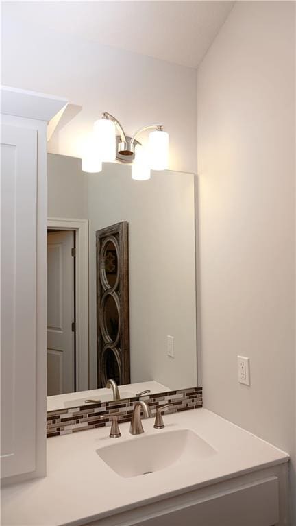 bathroom with decorative backsplash and vanity