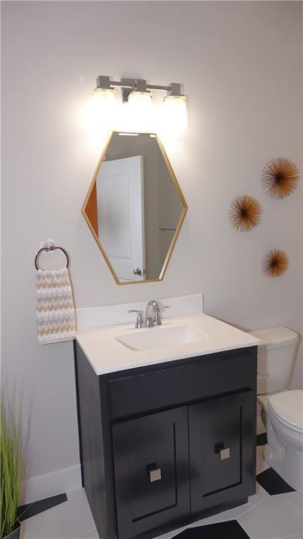 bathroom with vanity, toilet, and tile patterned floors