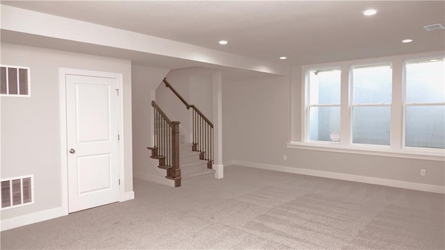 basement with carpet, visible vents, and recessed lighting