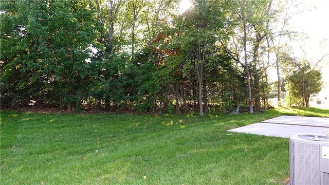 view of yard featuring a patio and central AC unit