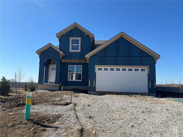 view of front of house featuring gravel driveway and an attached garage