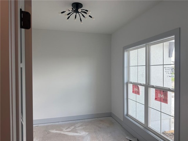 17388 S Kaw St, Olathe, KS 66062 - spare room featuring baseboards and a chandelier
