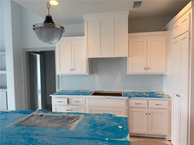 17388 S Kaw St, Olathe, KS 66062 - kitchen featuring backsplash, white cabinetry, and washer / clothes dryer