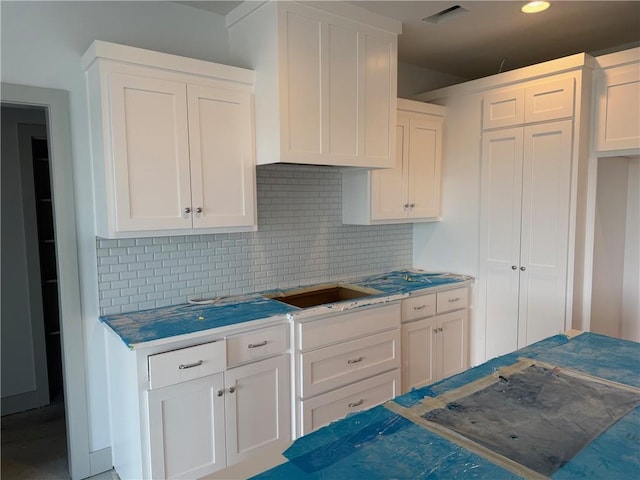 17388 S Kaw St, Olathe, KS 66062 - kitchen featuring backsplash, white cabinets, and recessed lighting