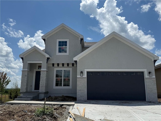 17388 S Kaw St, Olathe, KS 66062 - view of front of house featuring stucco siding, an attached garage, and concrete driveway
