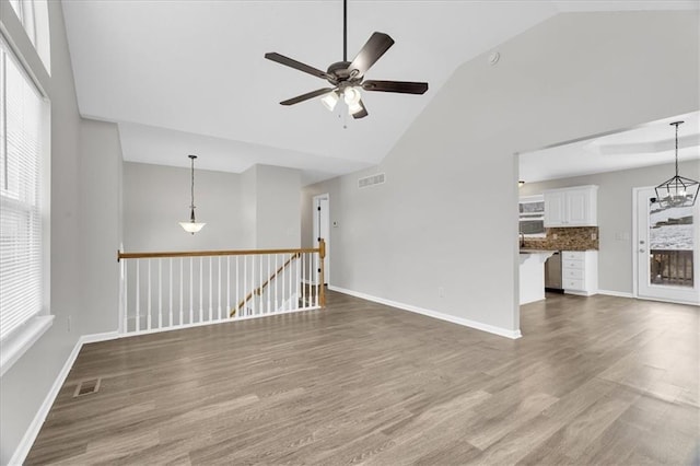 spare room with a wealth of natural light, visible vents, and wood finished floors