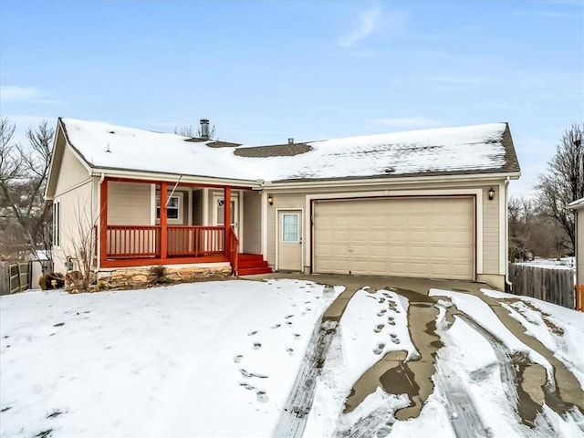 ranch-style house featuring a porch, an attached garage, and fence