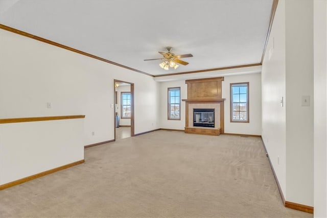 unfurnished living room featuring light carpet, ornamental molding, a fireplace, and baseboards