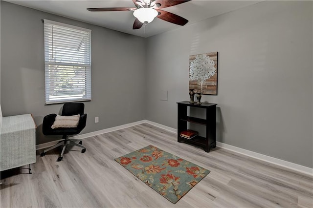 office space with baseboards, wood finished floors, and a ceiling fan