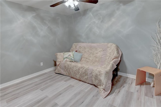 sitting room with wood finished floors, baseboards, and ceiling fan