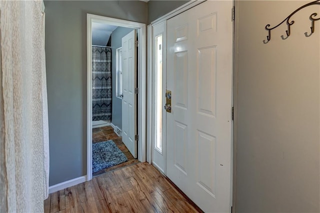 entryway with wood finished floors and baseboards