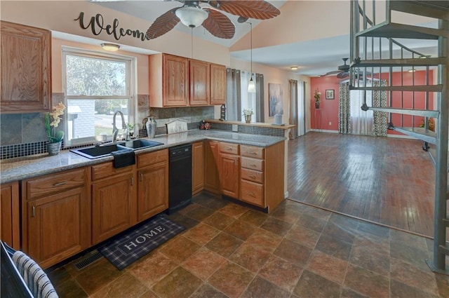 kitchen with a sink, backsplash, a peninsula, light countertops, and ceiling fan