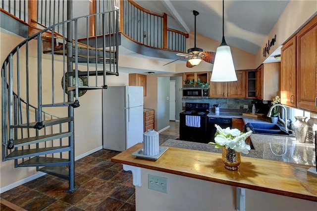 kitchen with black appliances, butcher block countertops, brown cabinetry, and a sink