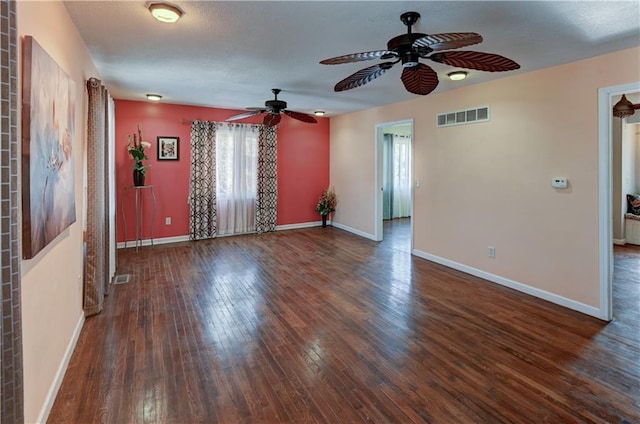 spare room featuring hardwood / wood-style flooring, baseboards, and visible vents