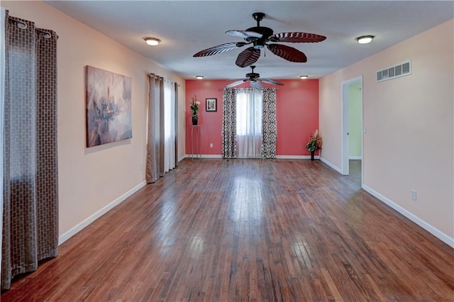 spare room featuring a ceiling fan, hardwood / wood-style flooring, baseboards, and visible vents