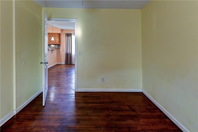 empty room with wood finished floors and baseboards