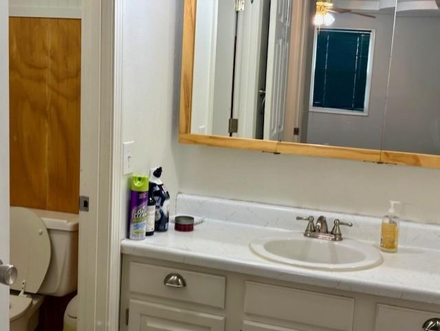 half bath featuring toilet and vanity