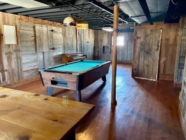 game room with dark wood-style flooring, pool table, and wood walls