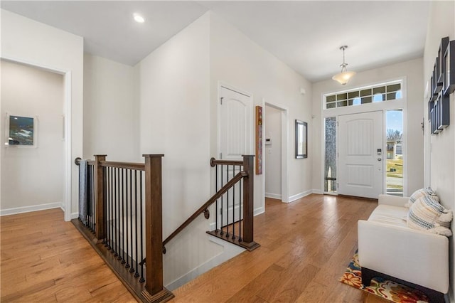 foyer featuring recessed lighting, light wood-style flooring, and baseboards