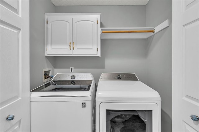 laundry room featuring cabinet space and separate washer and dryer