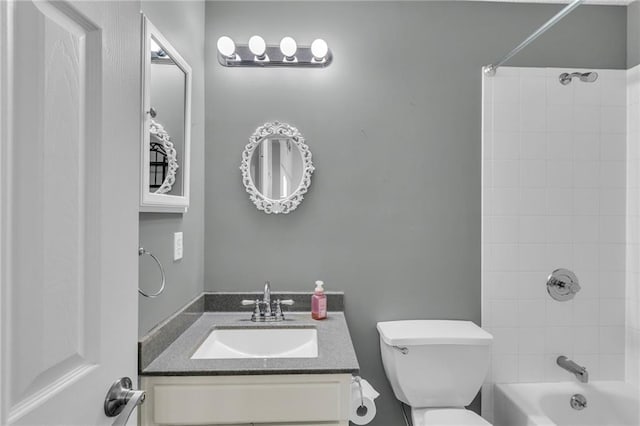 bathroom with shower / bath combination, toilet, and vanity