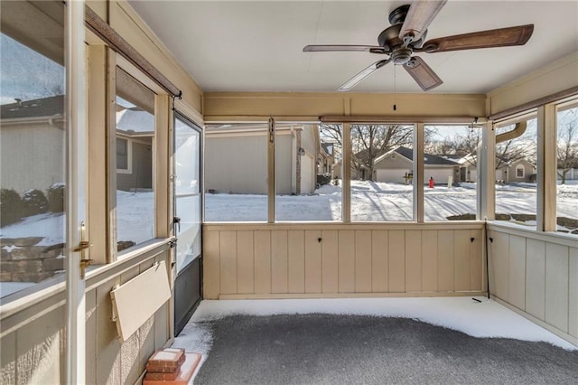 unfurnished sunroom with a ceiling fan