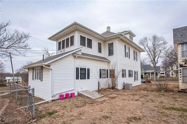 rear view of property with fence