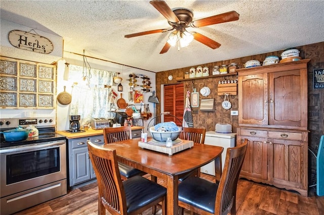 dining area featuring a textured ceiling, a ceiling fan, and dark wood-style flooring