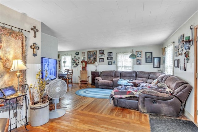 living area with plenty of natural light and wood finished floors