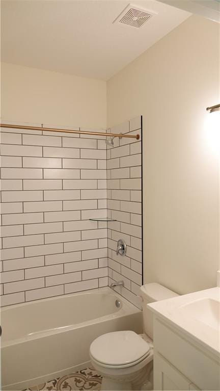 bathroom with toilet, vanity, visible vents, shower / washtub combination, and tile patterned floors