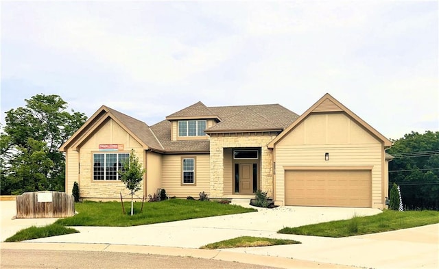 22312 W 76th St, Shawnee, KS 66227 - view of front of home featuring stone siding, concrete driveway, a front yard, a garage, and roof with shingles