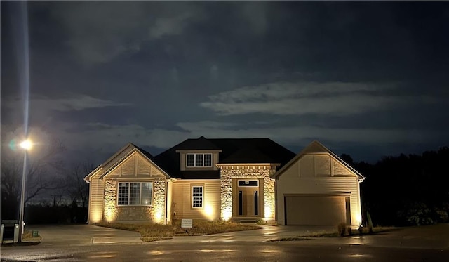 22312 W 76th St, Shawnee, KS 66227 - view of front of house with stone siding, concrete driveway, and a garage