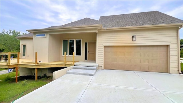22312 W 76th St, Shawnee, KS 66227 - view of front of home featuring driveway, an attached garage, roof with shingles, and a deck