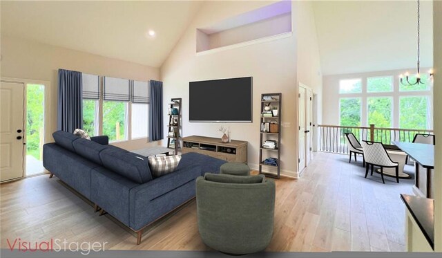 22312 W 76th St, Shawnee, KS 66227 - living area with high vaulted ceiling, a chandelier, and light wood-style flooring