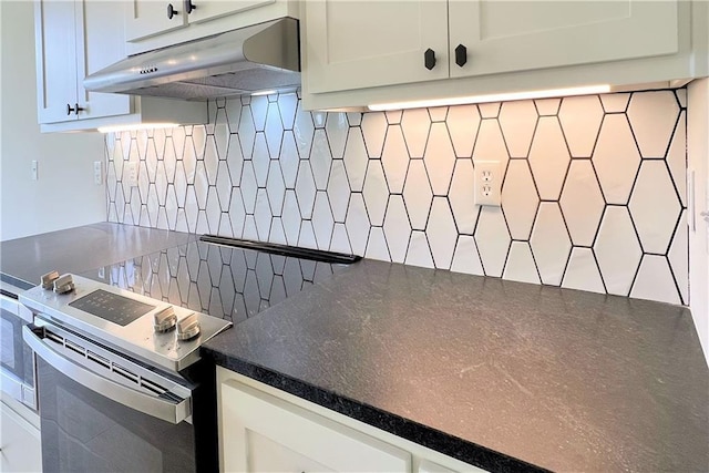 22312 W 76th St, Shawnee, KS 66227 - kitchen featuring under cabinet range hood, electric stove, decorative backsplash, dark countertops, and white cabinetry